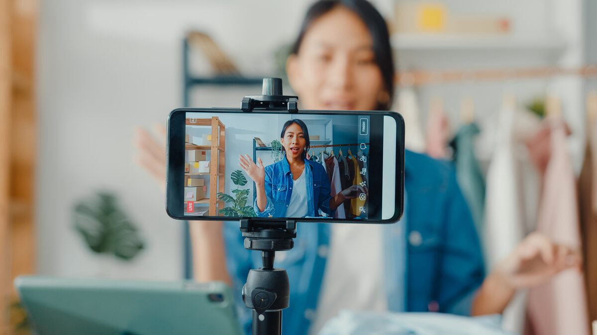 Photo of influencer filming content for social media